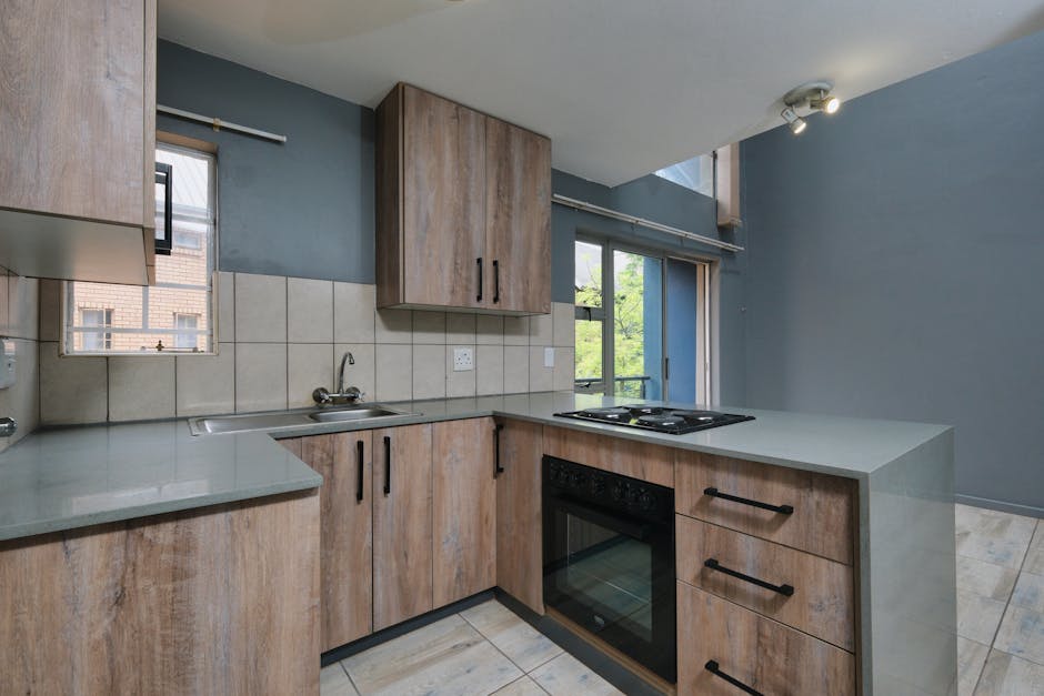 Contemporary kitchen with wood cabinetry and modern appliances for stylish living.