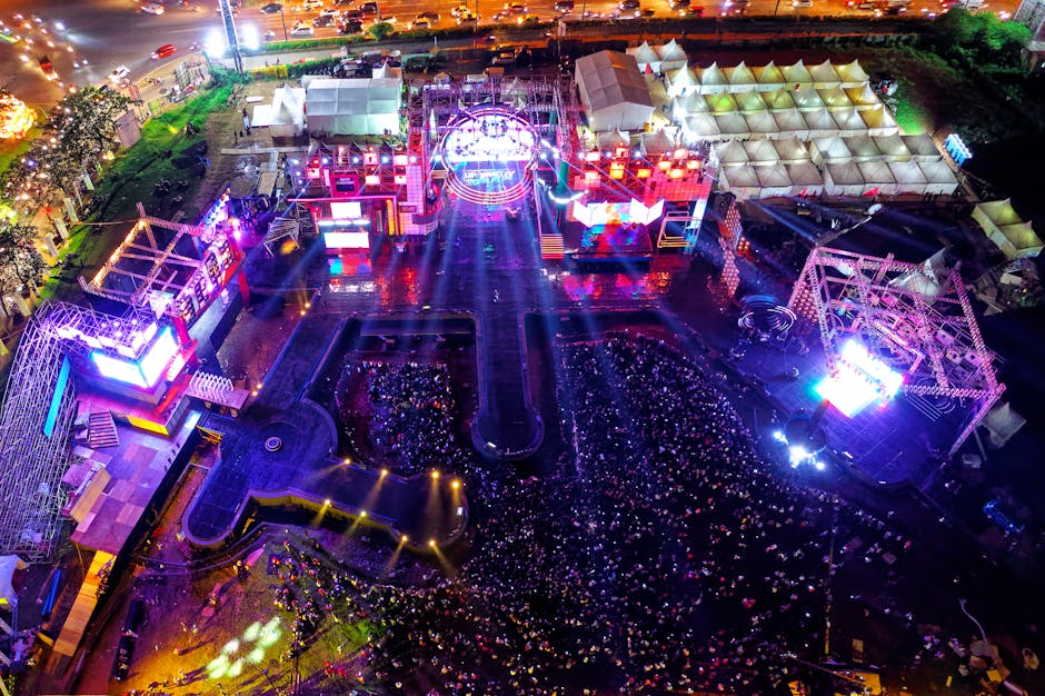 Aerial view of a vibrant music festival in Serpong, Indonesia with crowds and stage lights.