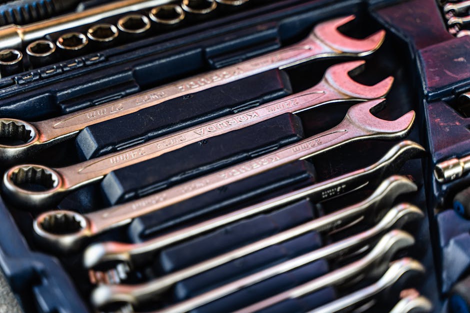 Detailed shot of a neatly arranged set of wrenches in a toolbox.